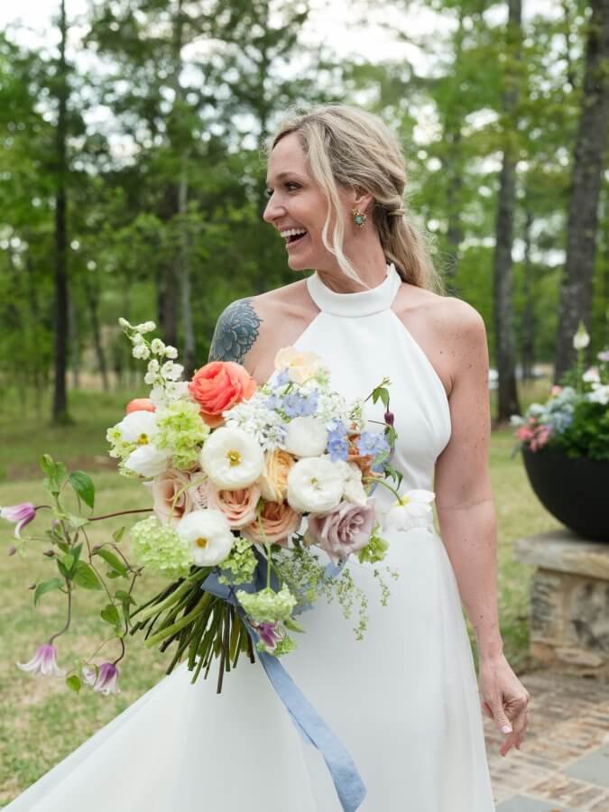 Hansell Smith in her wedding dress, holding her bouquet.
