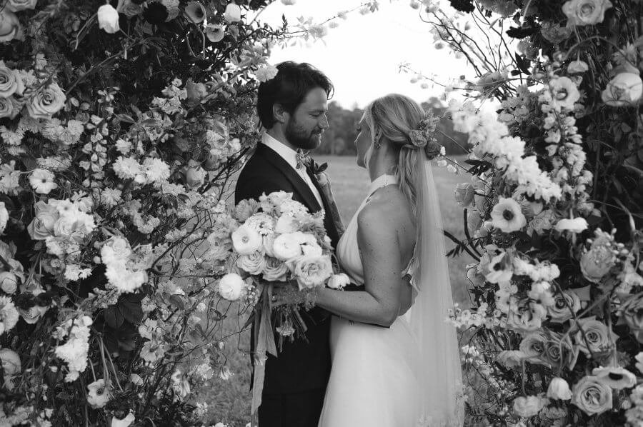 Hansell and Matt get ready to kiss under their flower arch