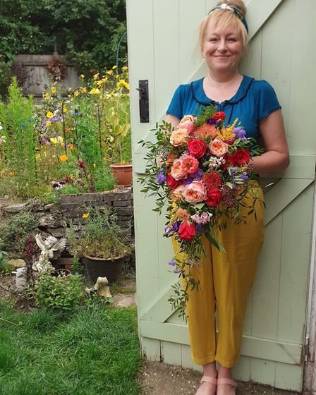 Danielle Wyatt with a colourful flower arrangement. 