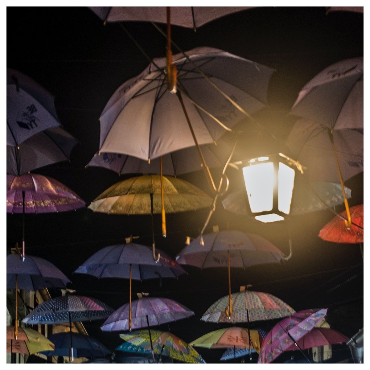 Quirky entrance with jewel-toned umbrellas