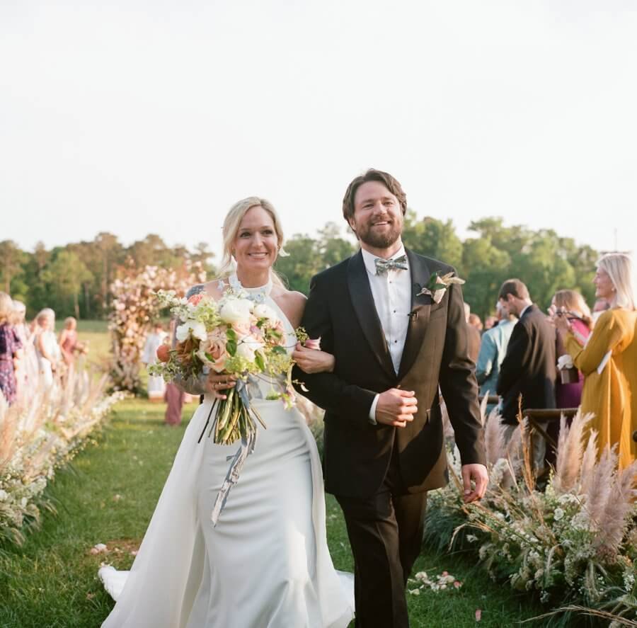 Matt and Hansell walking up the aisle at their wedding